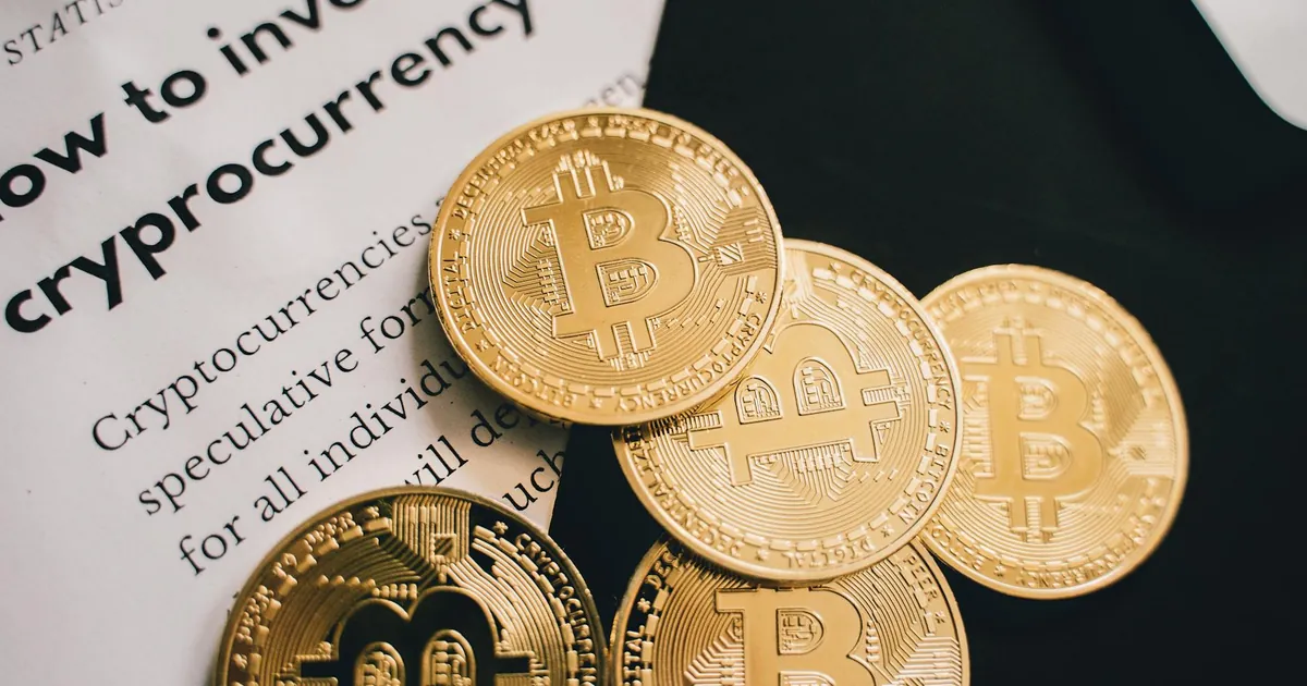 Close-up of Bitcoin coins alongside an investment guide in cryptocurrency.