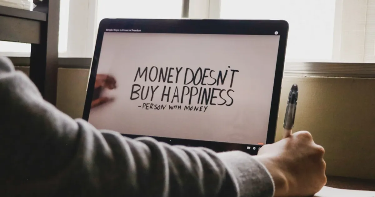 a person writing on a computer screen with a pen