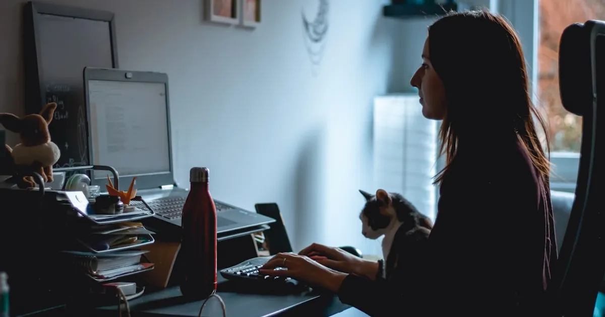 woman in black long sleeve shirt using laptop computer