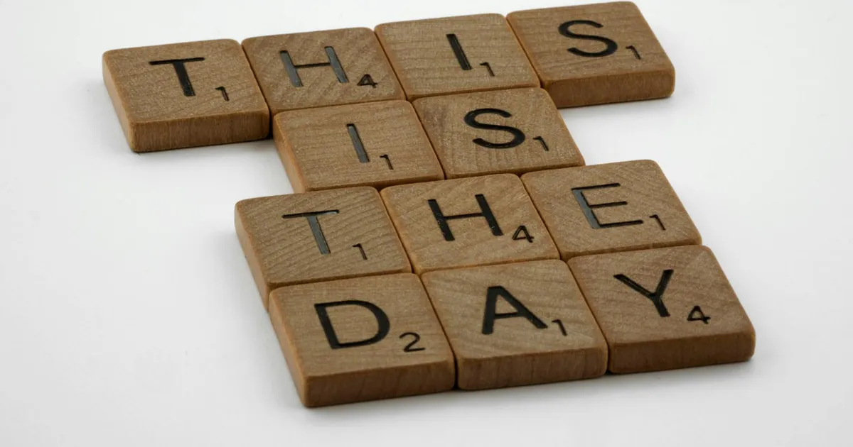 Scrabble tiles spell 'This is the Day' on a white background, inspiring change.