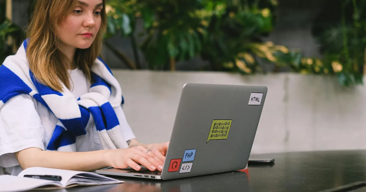 Young woman with a laptop working in a modern indoor space, showcasing freelance and digital nomad lifestyle. Young woman with a laptop working in a modern indoor space, showcasing freelance and digital nomad lifestyle.