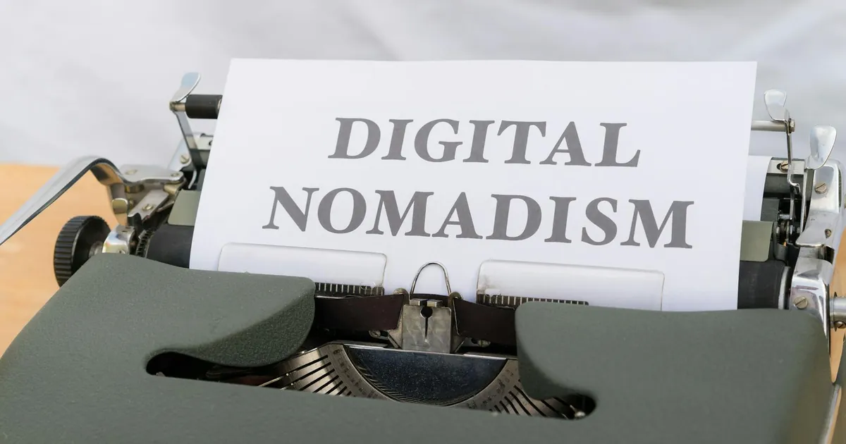 A vintage typewriter displaying the text 'Digital Nomadism,' symbolizing the modern remote work trend.