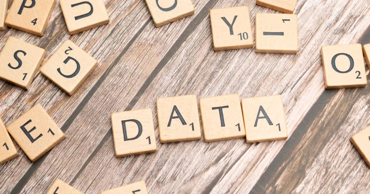 scrabble tiles spelling out the word data on a wooden surface