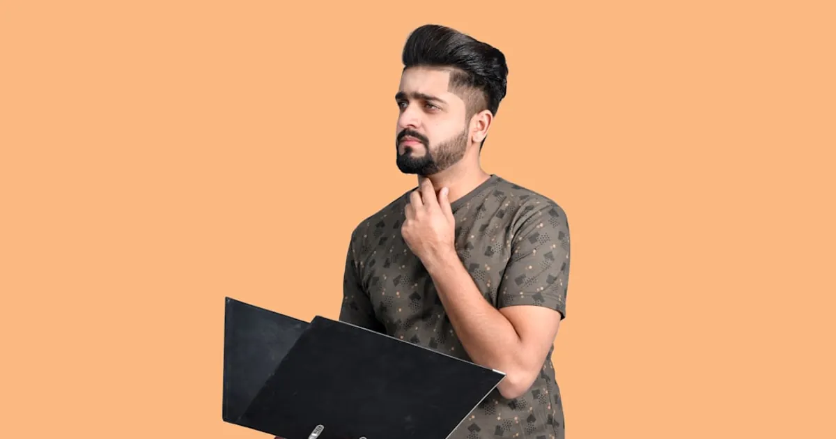 a man holding a laptop
