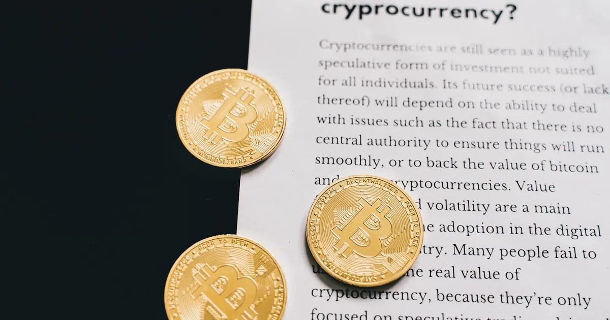 Gold Bitcoin coins on top of a cryptocurrency investment guide. High-quality finance and cryptocurrency image.