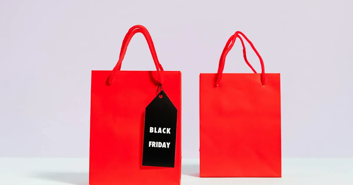Red shopping bags with Black Friday sale tag perfect for promotions and discounts.
