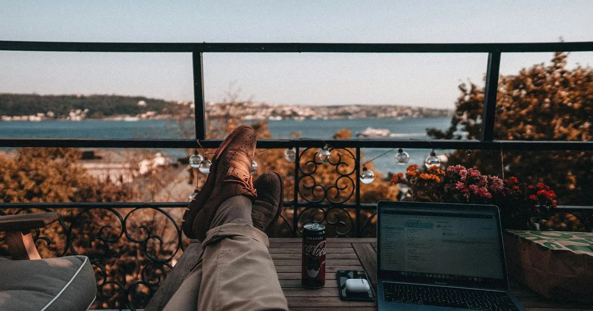 Enjoy a tranquil work-from-home setup with a serene balcony view and essentials.