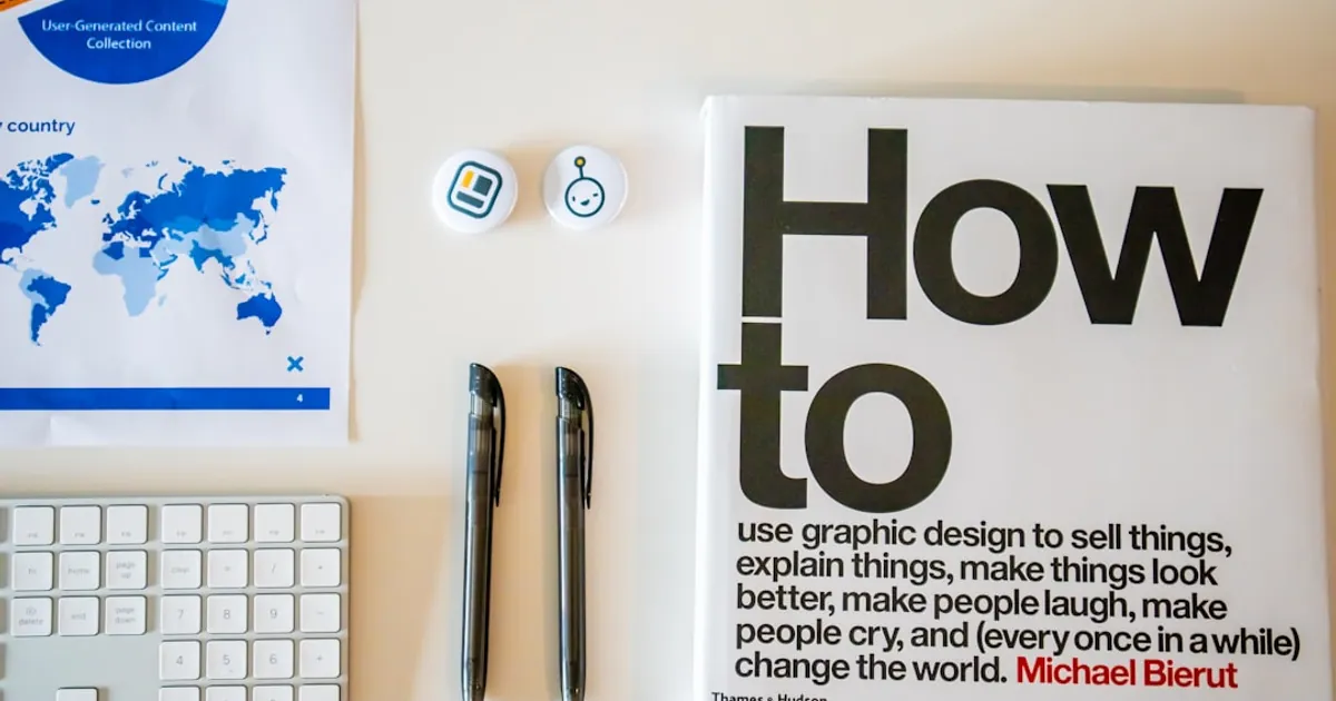 a magazine sitting on top of a desk next to a keyboard